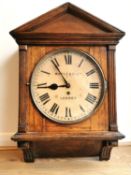 An early 20th century mahogany architectural design wall clock, the circular painted dial signed