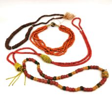Four African Tribal Beaded Necklaces, one from Ghana comprised of graduated discs of Bauxite (