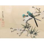 An early 20th century framed and glazed Japanese gouache on silk of two long tailed birds in a