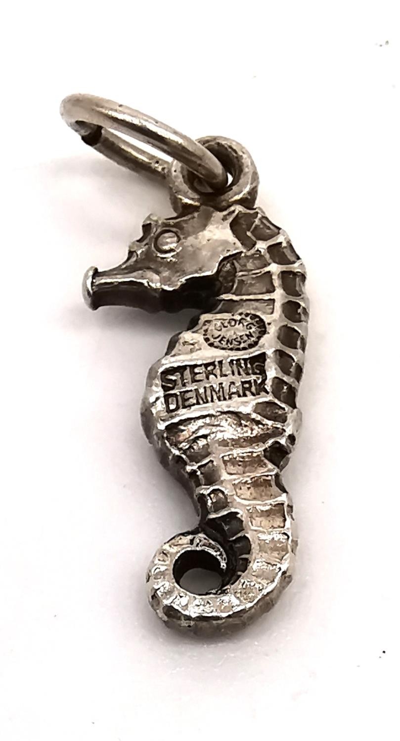 A collection of five Georg Jensen silver charms: a seahorse, an elephant, a carp, a pelican and a - Image 2 of 9