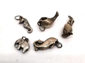 A collection of five Georg Jensen silver charms: a seahorse, an elephant, a carp, a pelican and a