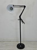 A floor standing anglepoise style floor lamp with adjustable head. H.172cm.