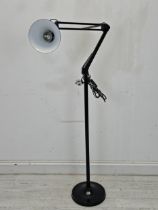 A floor standing anglepoise style floor lamp with adjustable head. H.172cm.