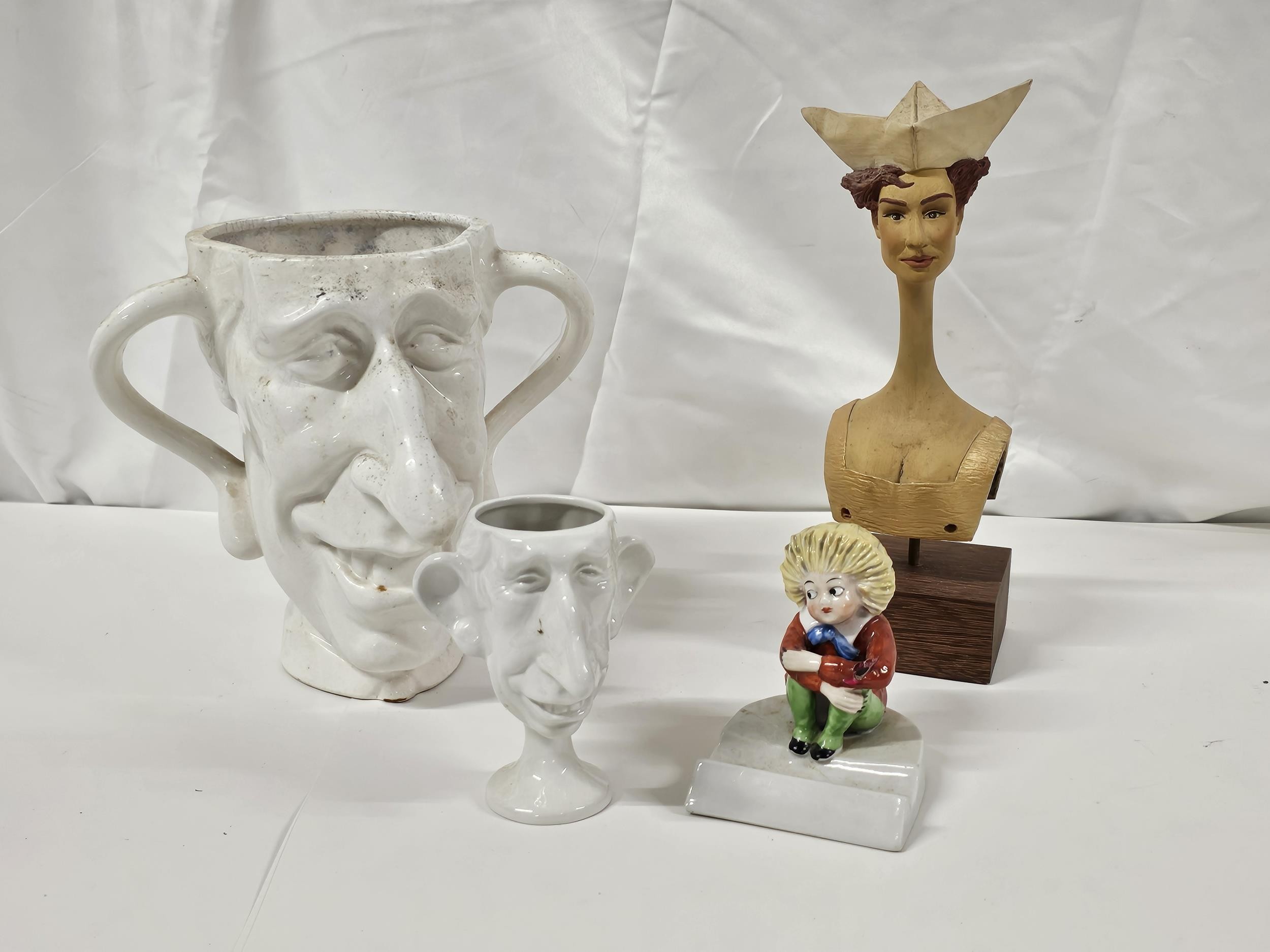 A collection of caricature ceramic items, including two spitting image King Charles mugs and a