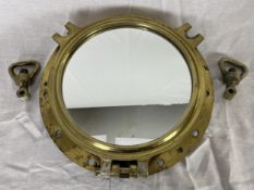 A brass ships porthole converted into a wall mirror. H.43 W.43 D.7cm.