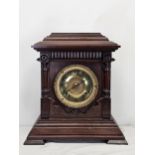 A late 19th century oak cased Ansonia mantel clock. H.38 W.35cm.