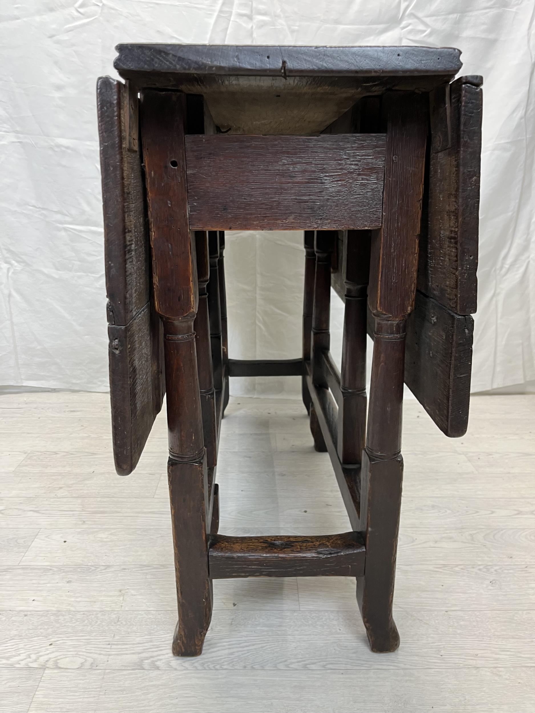 Dining table, 18th century oak with drop flap gateleg action. H.70 W.99 D.32cm. (extended W.98.5cm.) - Image 2 of 4