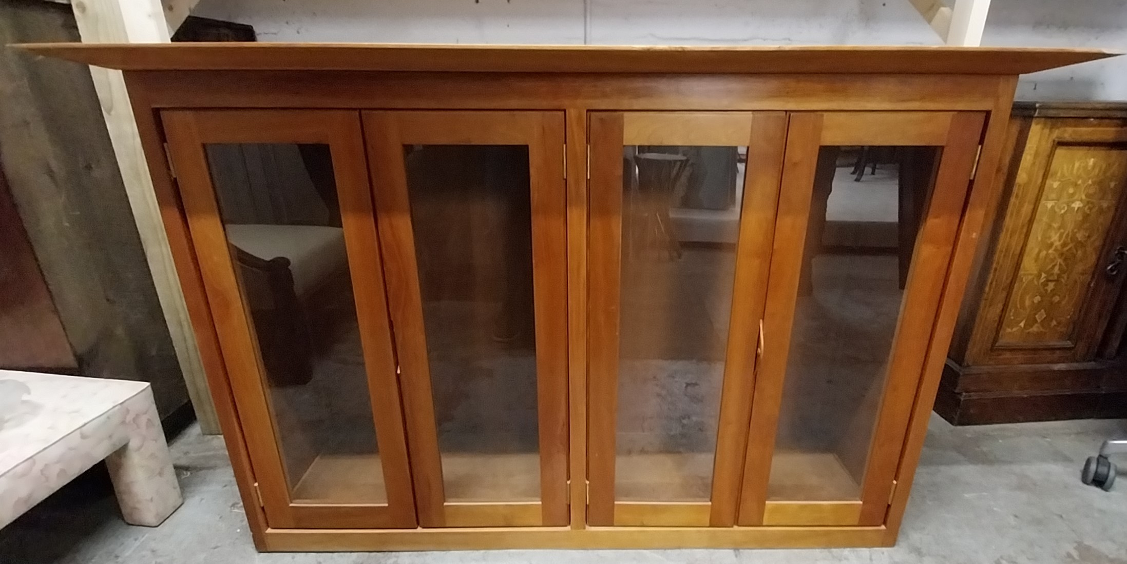 A contemporary glazed cabinet section. H.94 W.145 D.42cm.