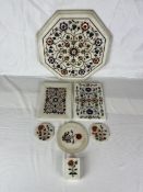 A collection of Indian pietra dura, a variety of semi- precious stones in white marble. Seven