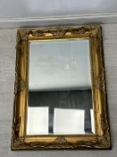 Wall mirror, contemporary foliate gilt frame with bevelled plate. H.96.5. W,71cm.