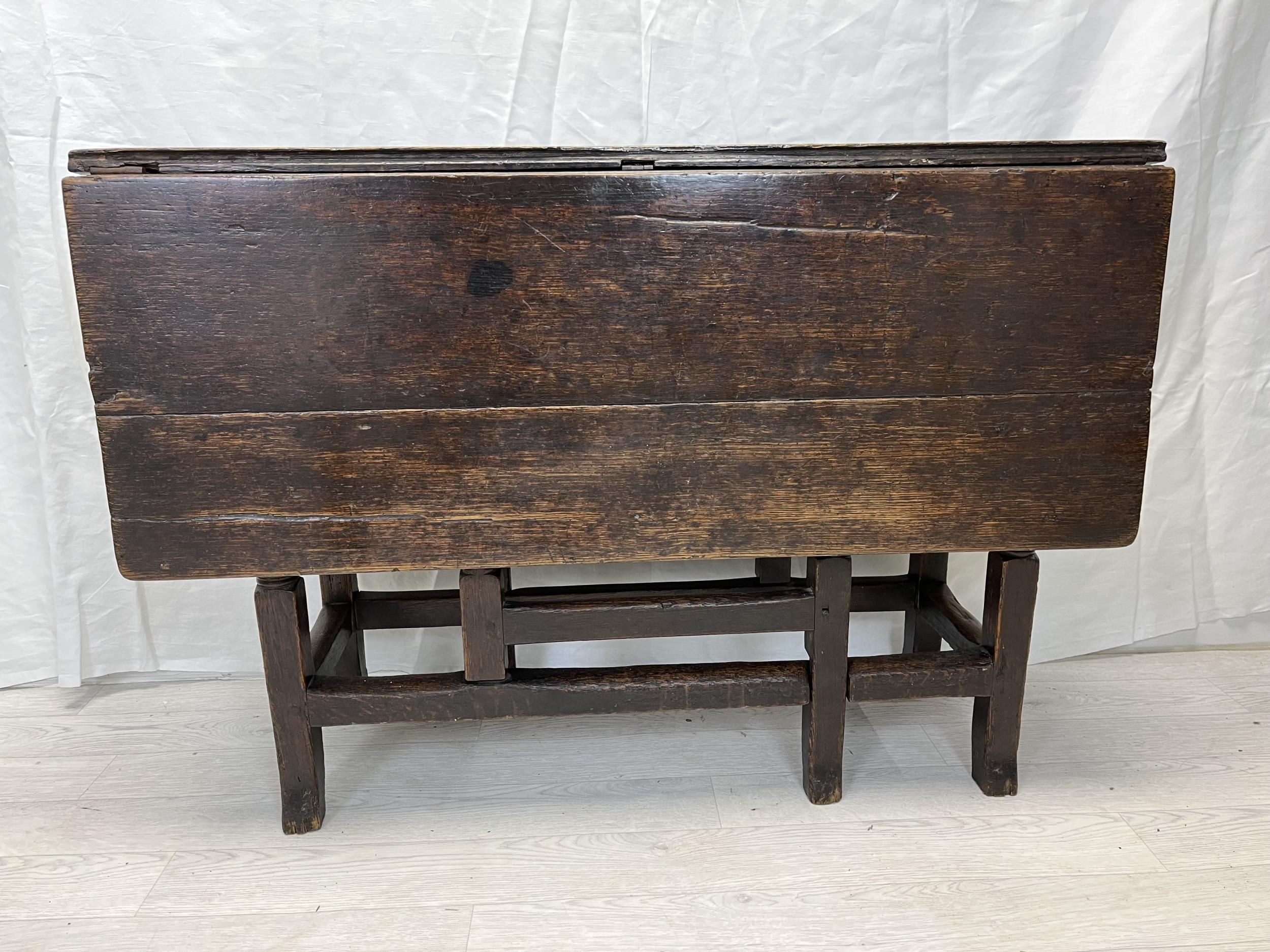 Dining table, 18th century oak with drop flap gateleg action. H.70 W.99 D.32cm. (extended W.98.5cm.)