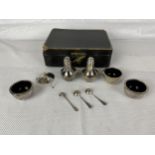 An English hallmarked cruet set, 162g, one piece and fitted box damaged as seen.