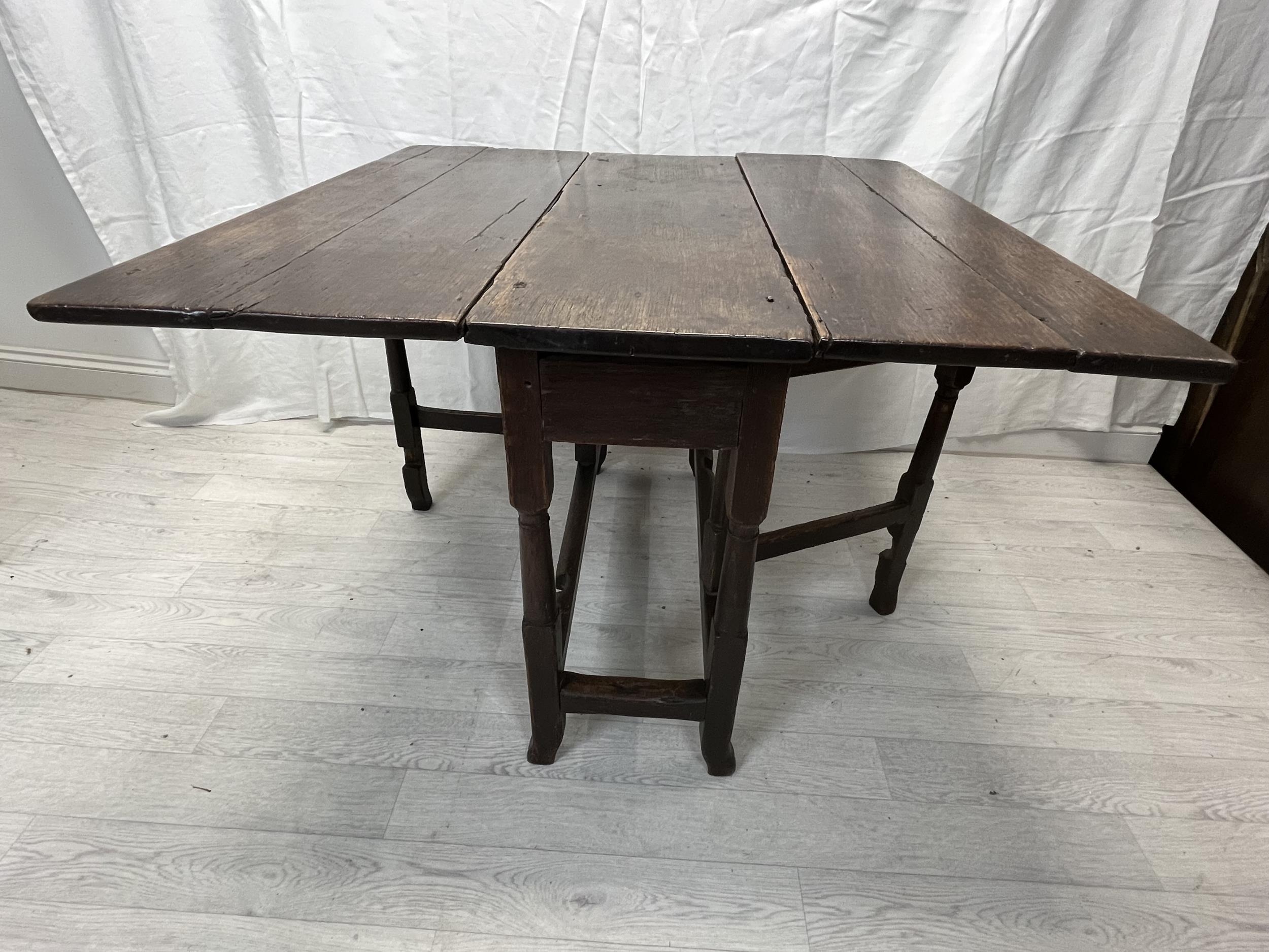 Dining table, 18th century oak with drop flap gateleg action. H.70 W.99 D.32cm. (extended W.98.5cm.) - Image 3 of 4