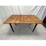 Dining table, possibly Gordon Rusell, mid century teak fitted with integral extension leaf. H.76 W.