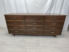 Sideboard, contemporary teak with a bank of twelve drawers. H.77 W.183 D.32cm.
