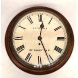 An early 20th century mahogany wall clock the dial signed for T T Clarke, 89A Brompton Road. H.15