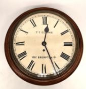 An early 20th century mahogany wall clock the dial signed for T T Clarke, 89A Brompton Road. H.15