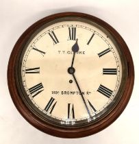 An early 20th century mahogany wall clock the dial signed for T T Clarke, 89A Brompton Road. H.15
