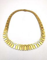 A 1980s 18 carat yellow gold Cleopatra graduated fringe collar necklace. The necklace with