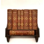 An early 20th century desk library by Asprey of London with complete set of leather bound books.