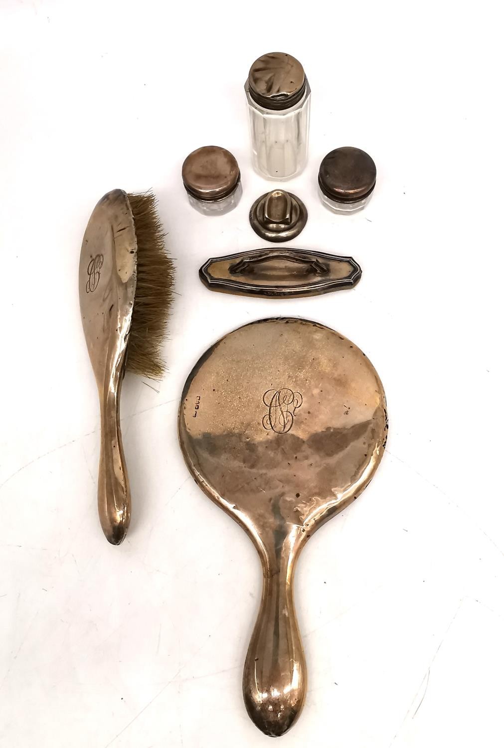 An Edwardian silver dressing table set by William Atkinson, consisting of a hand mirror, a hair