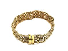 An Italian 18 carat yellow gold woven basket weave design bracelet. Fastens with a secure hidden
