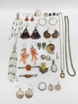 A collection of silver and white metal jewellery, including a ammonite suite of earrings and a