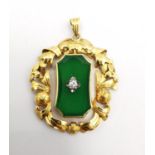 An early 20th century 14 carat yellow gold, jade and diamond pendant. The central jade panel set