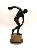 After the ancient 'Discobolus' the Discus thrower, an early 20th century patinated bronze, on