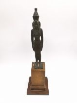 A 19th century Egyptian style bronze statue of an Egyptian god mounted on a wooden stand. H.20cm.