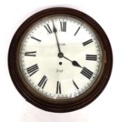 A early 20th century mahogany circular wall clock by Agar, York. Brass mechanism and white painted