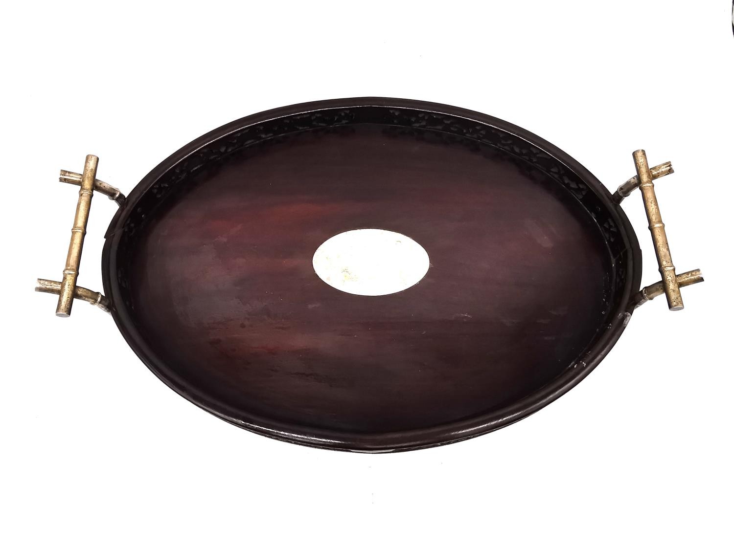 An early 20th century Chinese carved and pierced hardwood oval tray with white metal (tests as