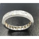 A white metal (tests as platinum) diamond set full eternity ring, set with twenty two round
