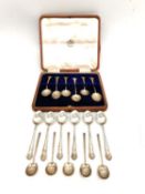 A leather cased set of six silver coffee spoons, six repousse silver teaspoons and five Art Deco