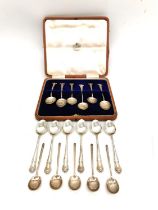 A leather cased set of six silver coffee spoons, six repousse silver teaspoons and five Art Deco
