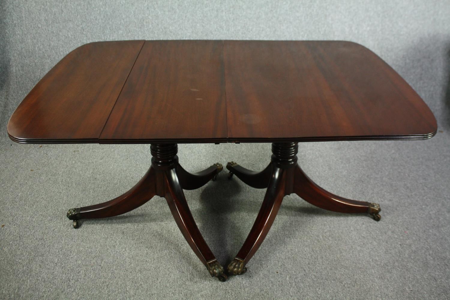 Dining table, Georgian style mahogany twin pillar with two extra leaves. H.74 W.245(ext) D.109cm. (