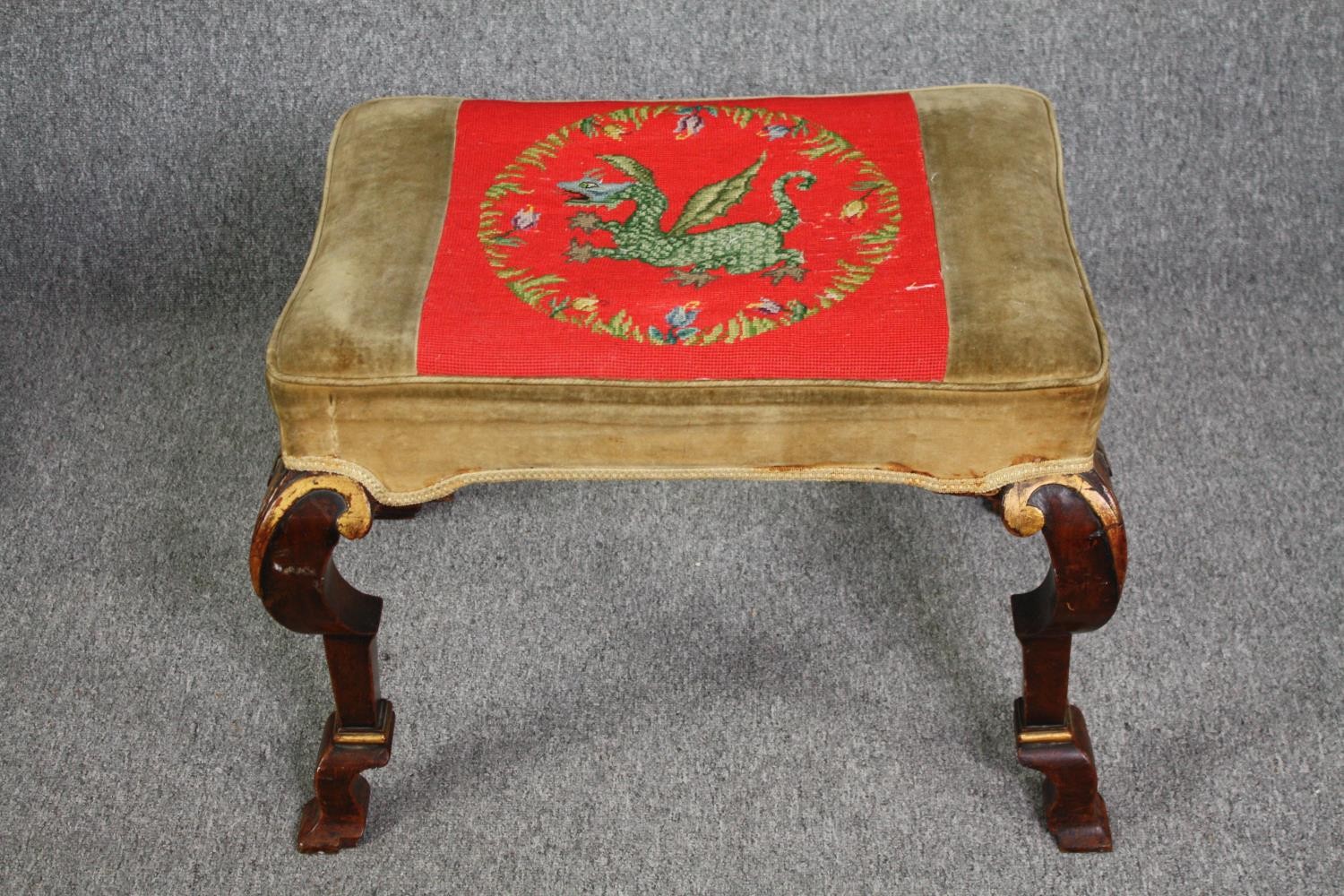 A Georgian walnut and gilt footstool with tapestry upholstered seat on cabriole supports. H.50 W.