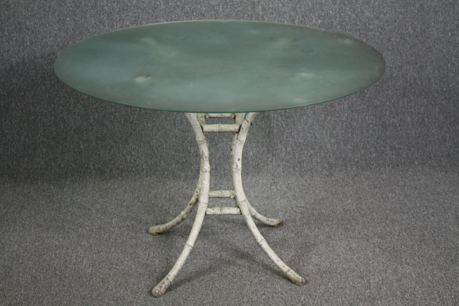 Garden or conservatory table, plate glass on faux bamboo painted metal base. H.75 Dia.107cm.