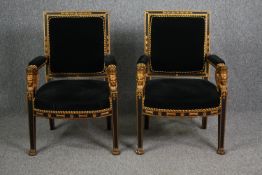 Armchairs, a pair, 19th century Empire style, ebonised and gilt. H.95cm. (Each).