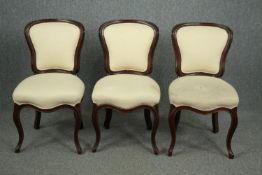 A set of three 19th century French mahogany dining chairs. Reupholstered and each resting on four
