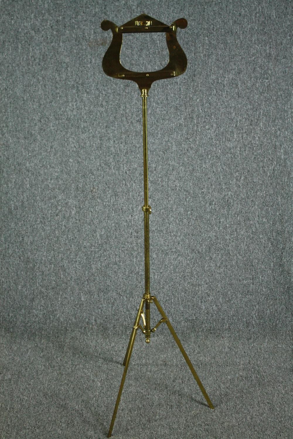 A modern folding brass music stand. H.130cm.