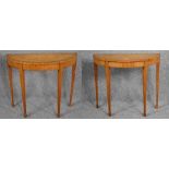 A pair of 19th century satinwood, ebony strung and crossbanded console tables raised on square