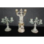 A pair of Meissen candelabras along with a larger similar example. H.38cm. (Largest). Repairs and