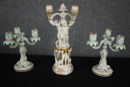 A pair of Meissen candelabras along with a larger similar example. H.38cm. (Largest). Repairs and