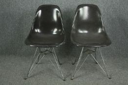 After Charles and Ray Eames, a pair of Eiffel style chairs stamped Modernica, with fibreglass shell