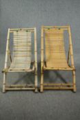 A pair of slatted bamboo deck chairs.