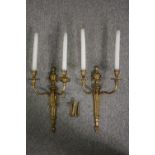 A pair of gilt metal Classical design brass twin branch wall sconces. H.66cm. (Each).