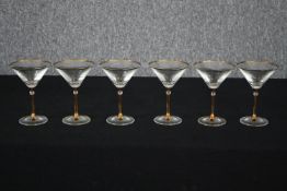 A set of six gilt rimmed martini glasses. H.15cm. (Each).
