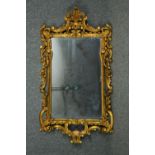 Wall mirror, C.1900 carved foliate scrolling giltwood. H.128 W.68cm.