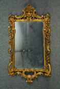 Wall mirror, C.1900 carved foliate scrolling giltwood. H.128 W.68cm.